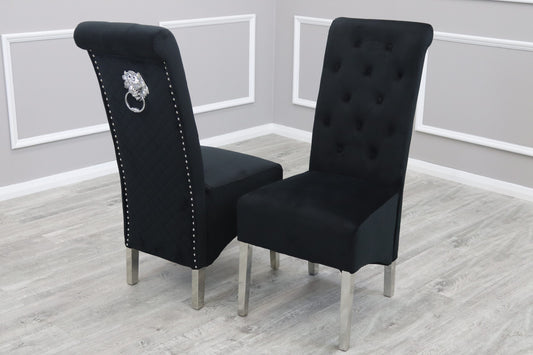 Set of two black velvet dining chairs with button-tufted backs, silver legs and decorative back rings