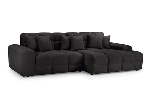 Large dark gray corner sofa with deep seats, broad arms, and loose back cushions