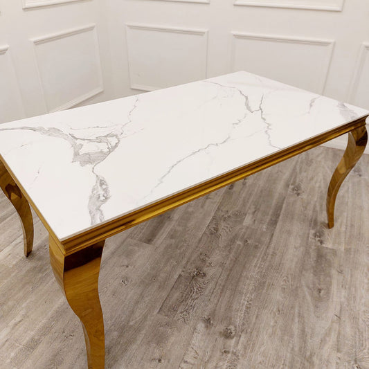 Louis Gold dining table with a white marble-look top and curved gold legs