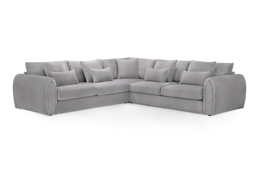 Large gray corner sofa with scatter cushions and rounded arms