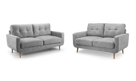 Gray two-seat sofa with tufted back cushions, broad arms, and tapered wooden legs