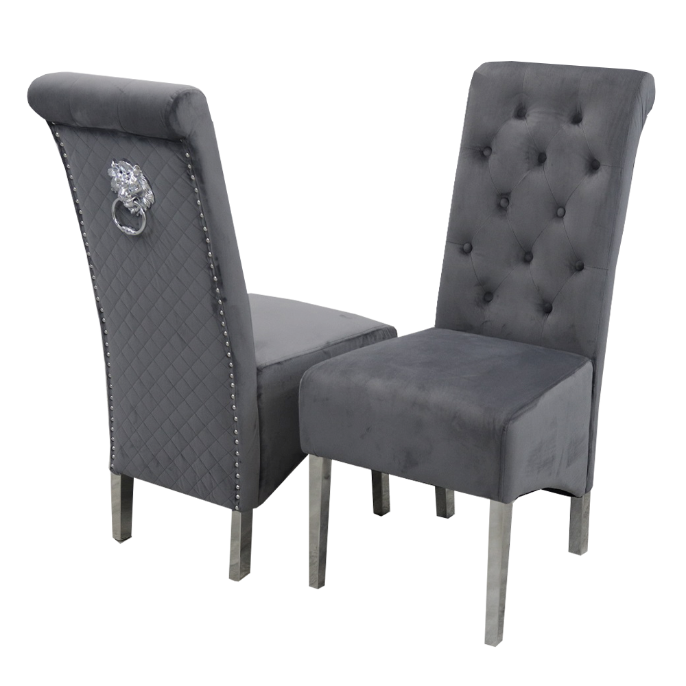 Pair of dark grey velvet dining chairs with tufted backs, quilted sides and lion-head ring pulls