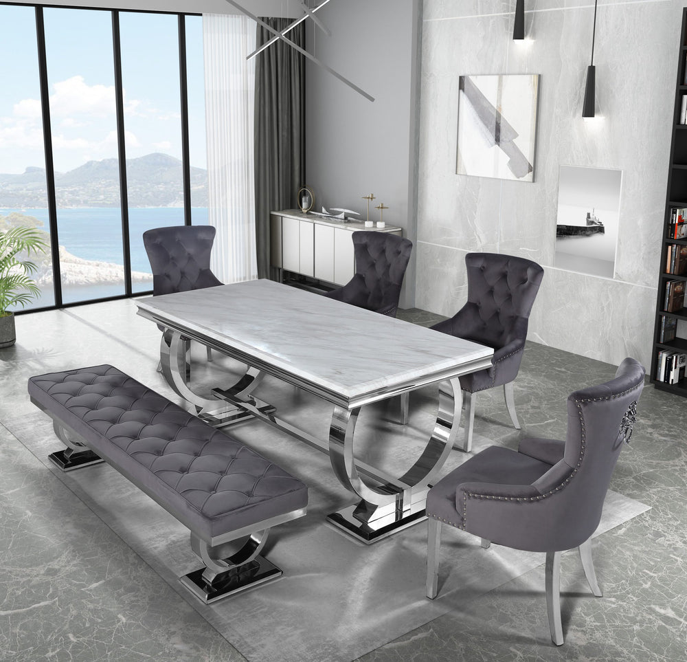 Arriana dining table with a light stone top and sculptural metal base, shown with dining chairs