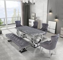 Arriana dining table with a dark veined stone top and chrome loop supports