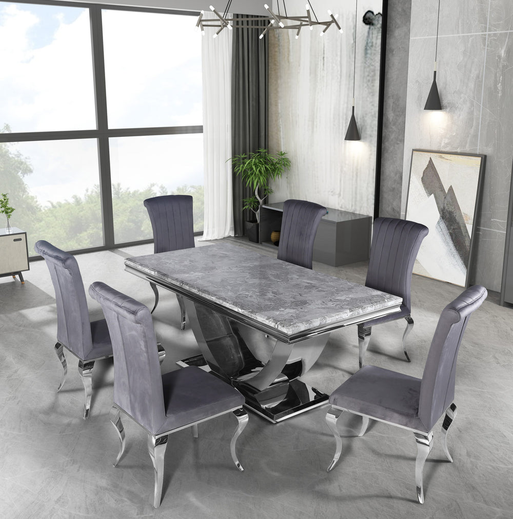 Arial dining table with gray stone top and chrome pedestal, surrounded by upholstered chairs