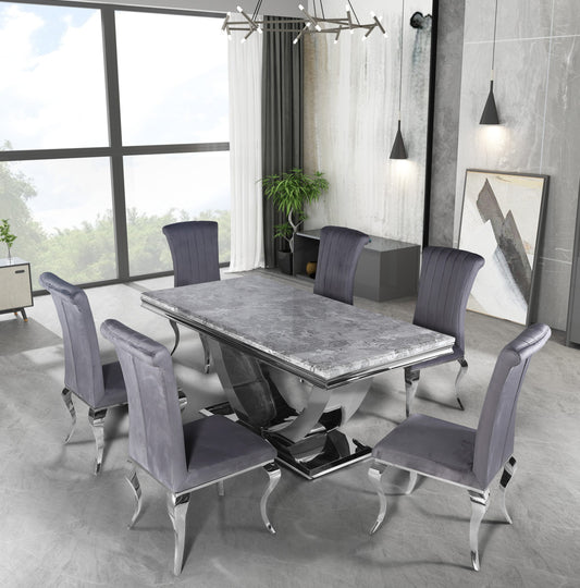 Arial dining table with gray stone top and chrome pedestal, surrounded by upholstered chairs