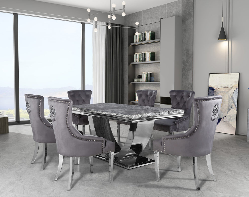 Arial dining table with gray veined top and sculptural metal base, set with upholstered chairs