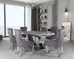 Arial dining table with gray veined top and sculptural metal base, set with upholstered chairs