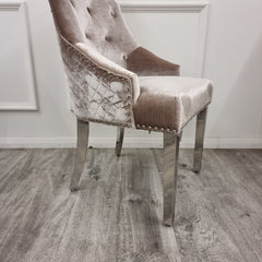 Beige velvet chair detail with quilted side panels, nailhead trim and chrome legs