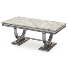 Arriana dining table with a pale veined stone top and polished metal loop legs