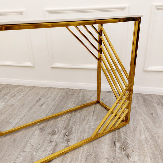 Gold metal console table frame with diagonal supports and a white top