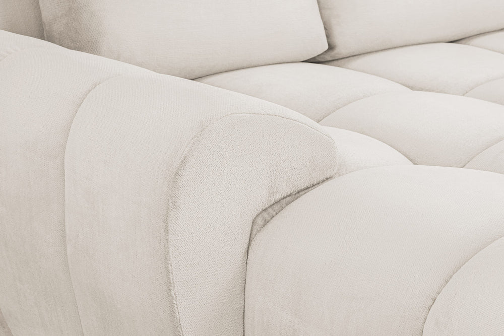 Azzuro sofa close-up showing textured cream upholstery and a rounded armrest