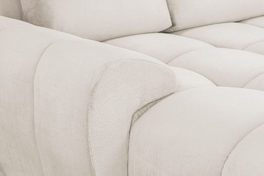 Azzuro sofa close-up showing textured cream upholstery and a rounded armrest