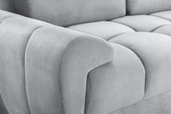 Azzuro sofa close-up of a rounded padded arm beside the tufted seat