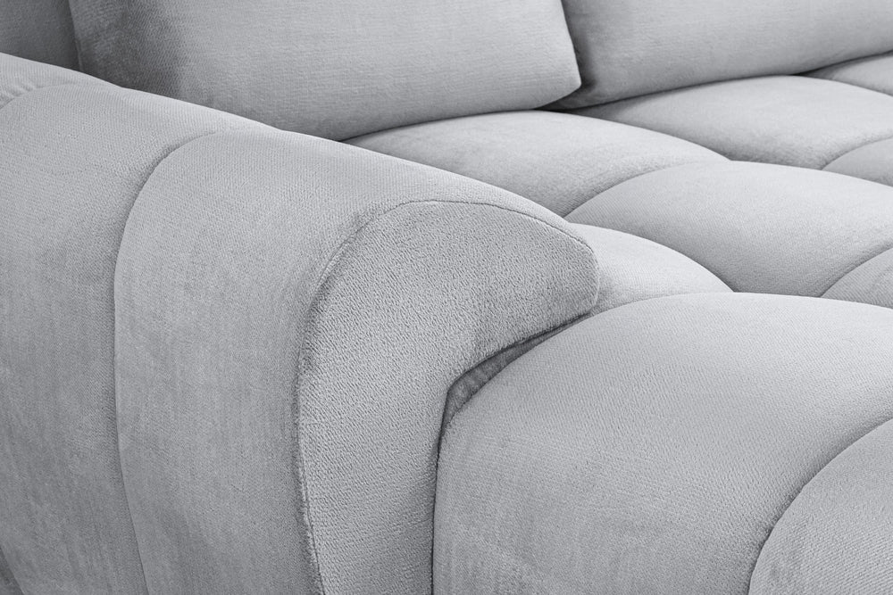 Azzuro sofa close-up of the rounded padded arm and tufted seat upholstery