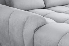 Azzuro sofa close-up of the rounded padded arm and tufted seat upholstery