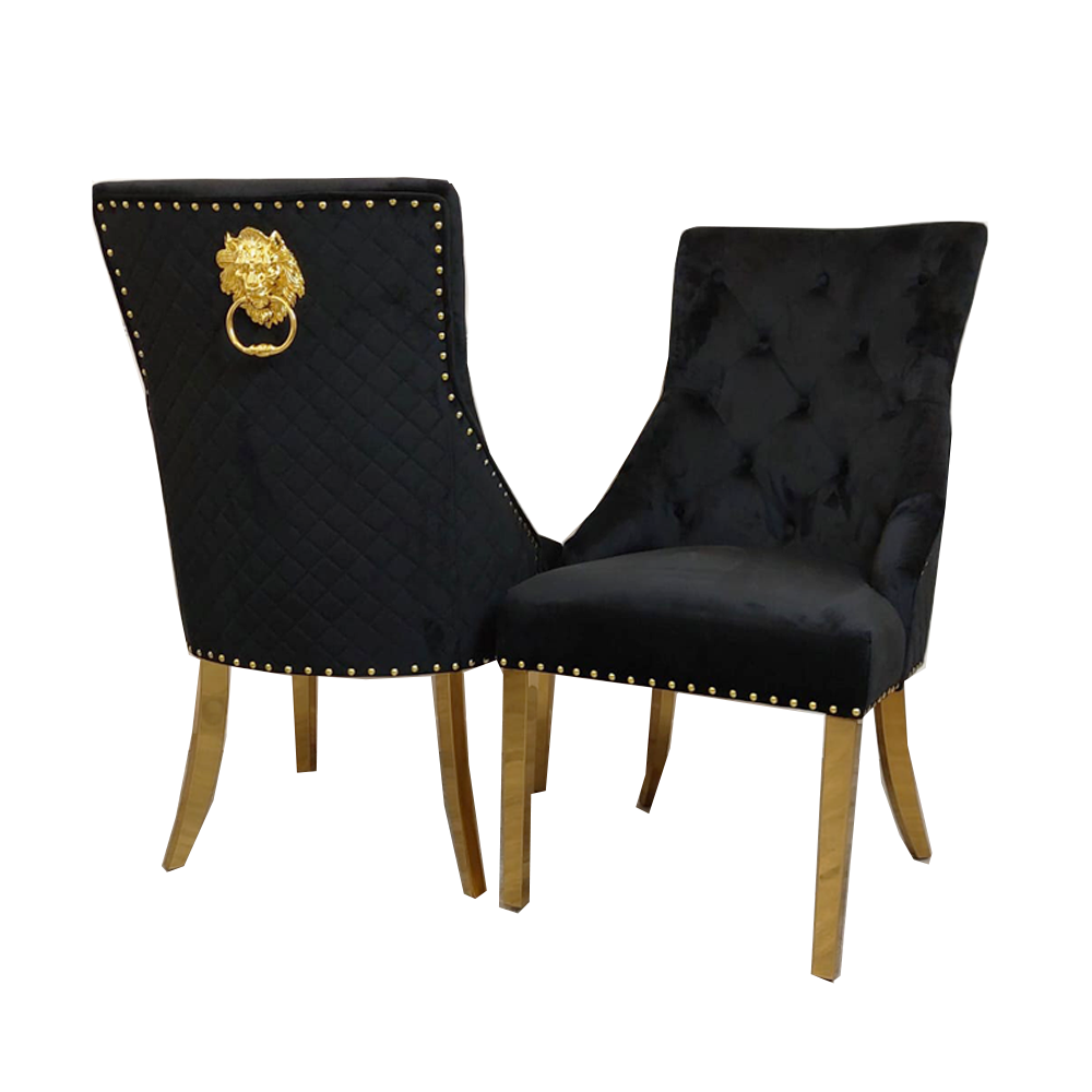 Pair of black velvet dining chairs with quilted backs, gold legs, and decorative gold back rings