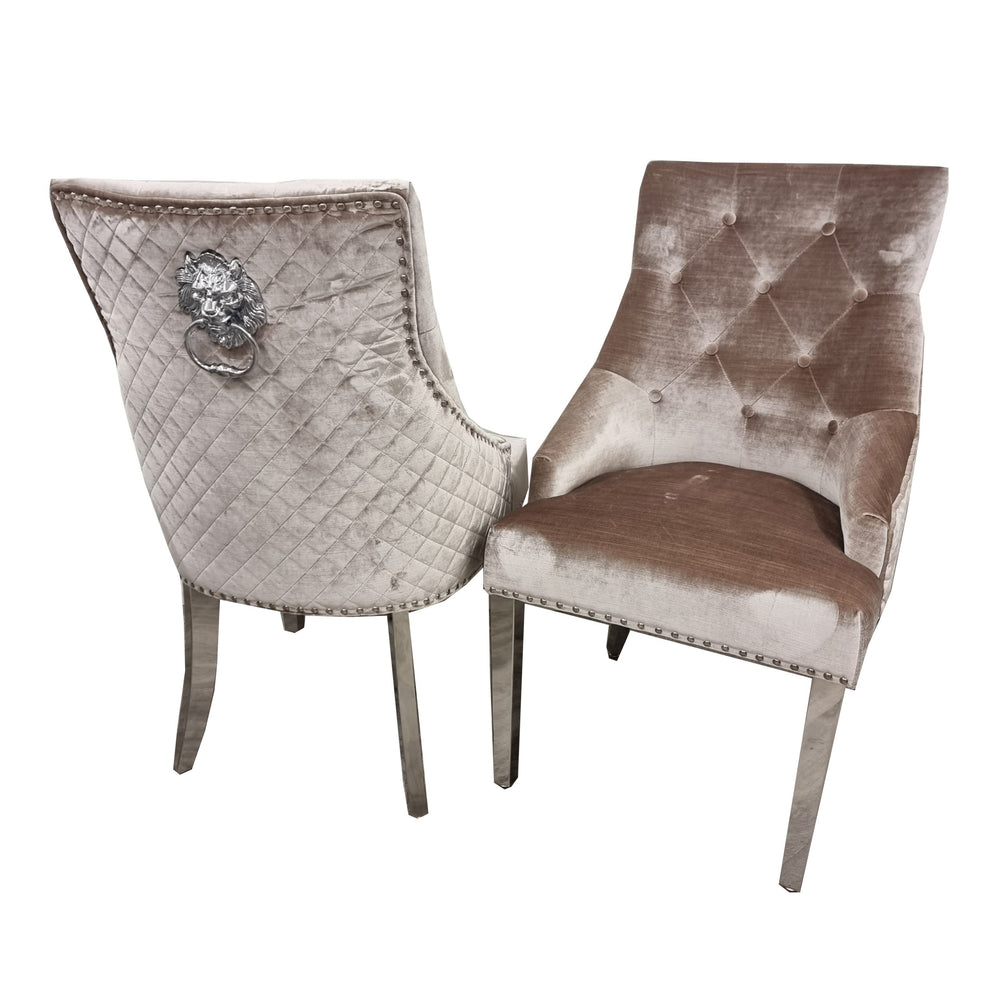 Pair of beige velvet dining chairs with tufted backs, quilted sides, chrome legs and lion-head accents