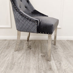 Velvet dining chair detail with tufted back, quilted side, nailhead trim, and chrome legs