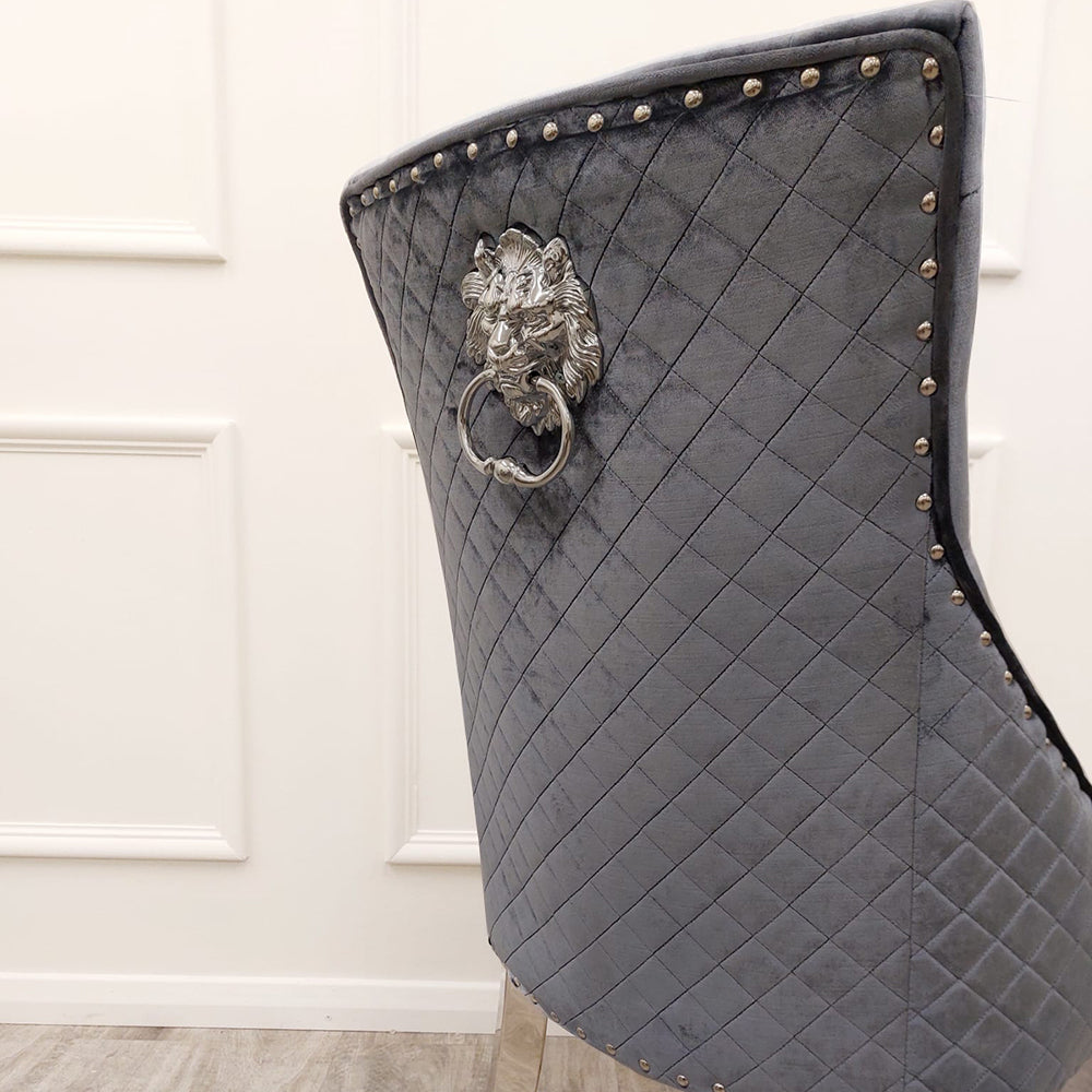 Dining chair back with diamond quilting, nailhead trim, and decorative lion-head ring