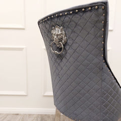 Dining chair back with diamond quilting, nailhead trim, and decorative lion-head ring