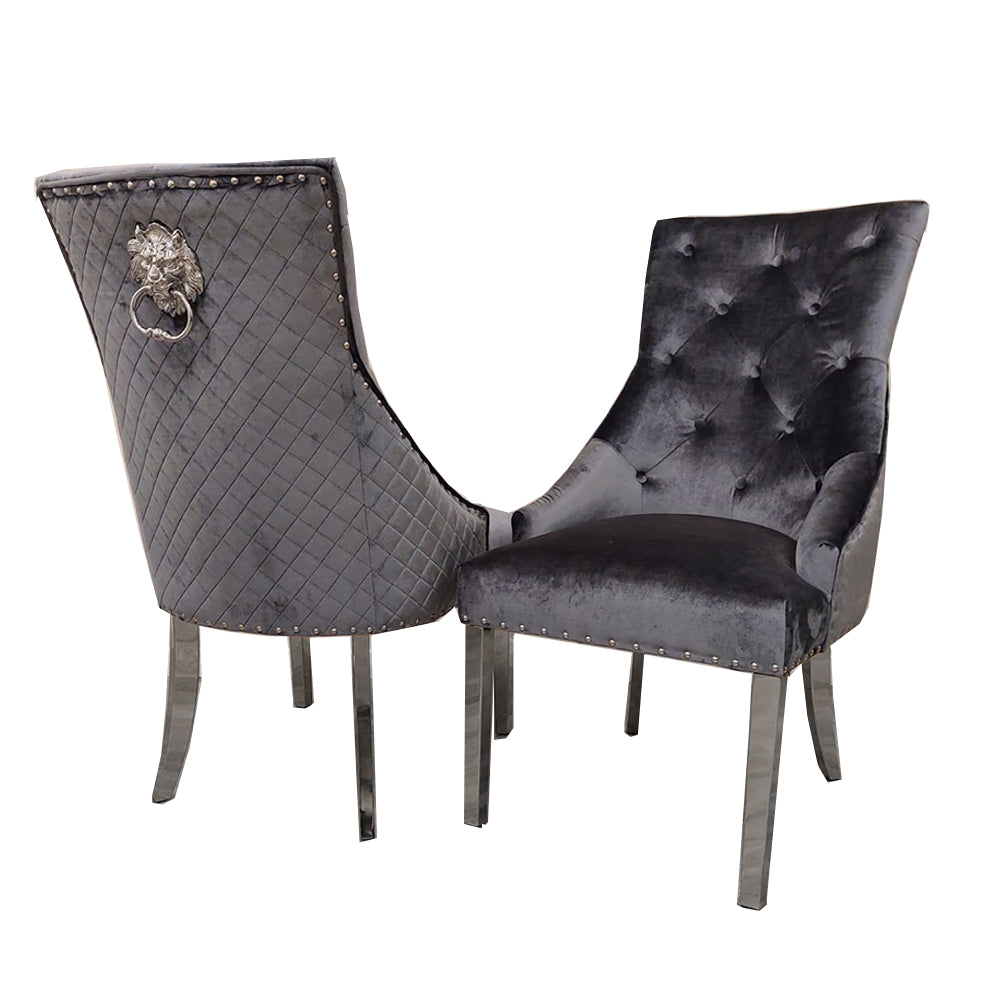 Pair of dark gray velvet dining chairs with tufted backs, quilted backs, and chrome legs
