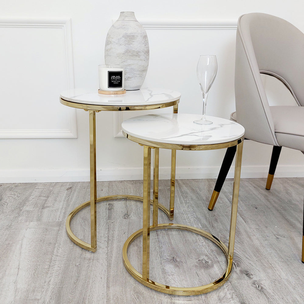 Set of two tall round end tables with white veined tops and gold ring bases