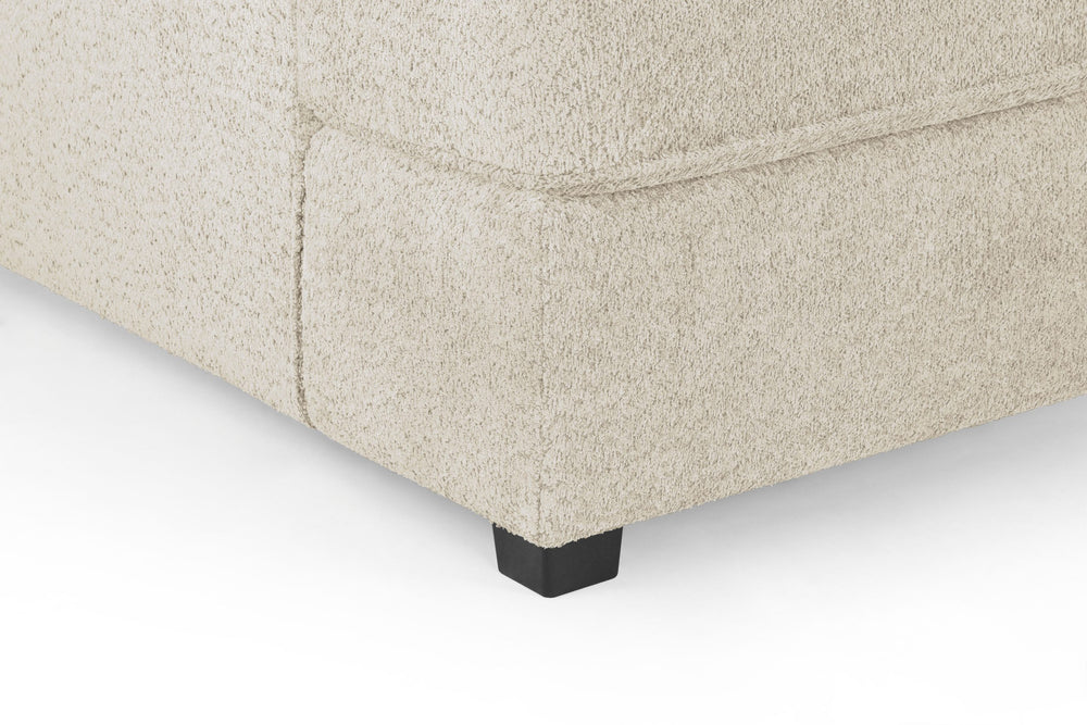 Carnaby sofa corner detail showing textured beige fabric and a black foot
