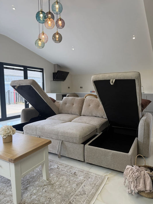 Light gray U-shaped sofa bed with lift-up chaise sections and storage compartments open.