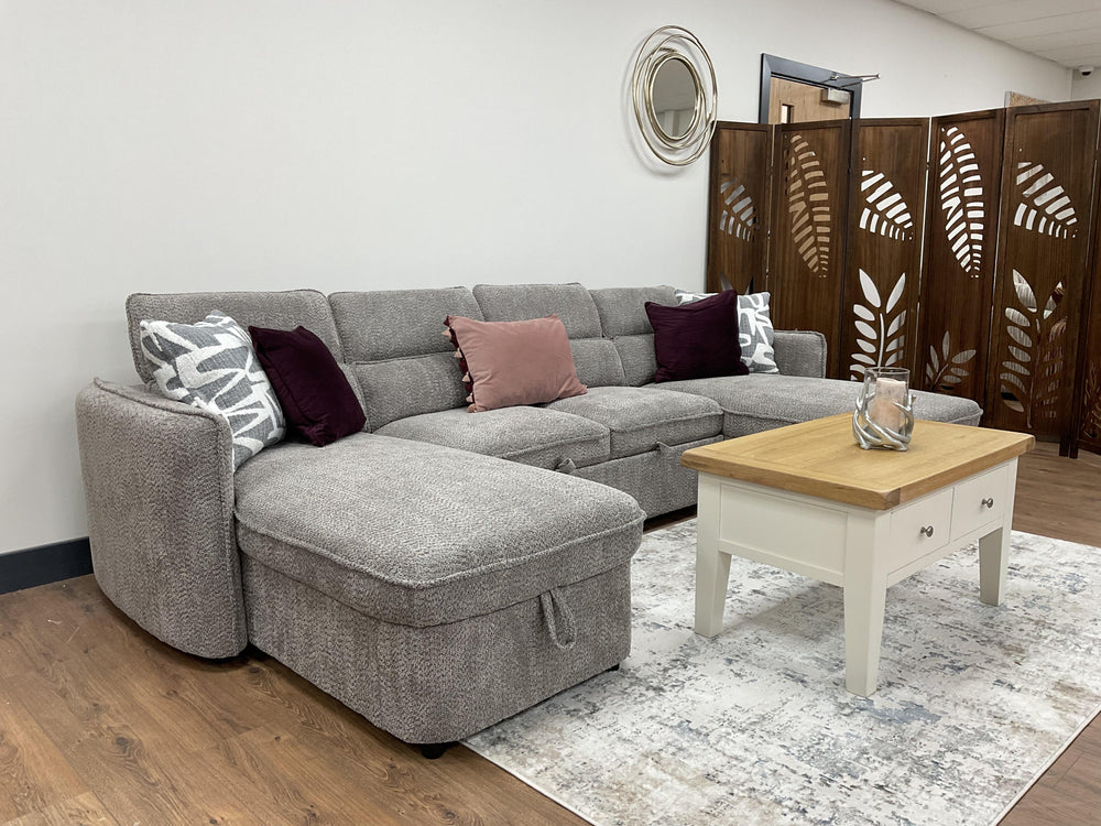Gray U-shaped sofa bed styled with throw pillows