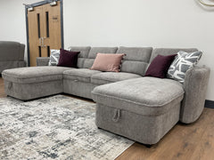 Gray U-shaped sofa bed with chaise ends and decorative pillows
