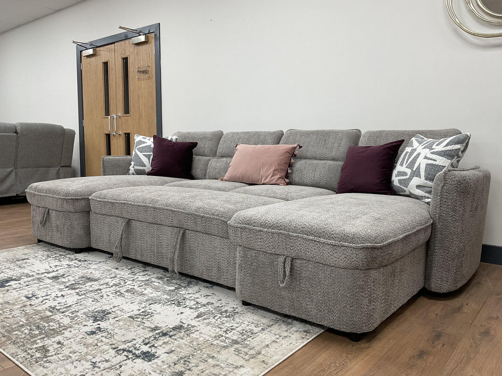 Gray sofa bed with wide chaise seats and decorative pillows