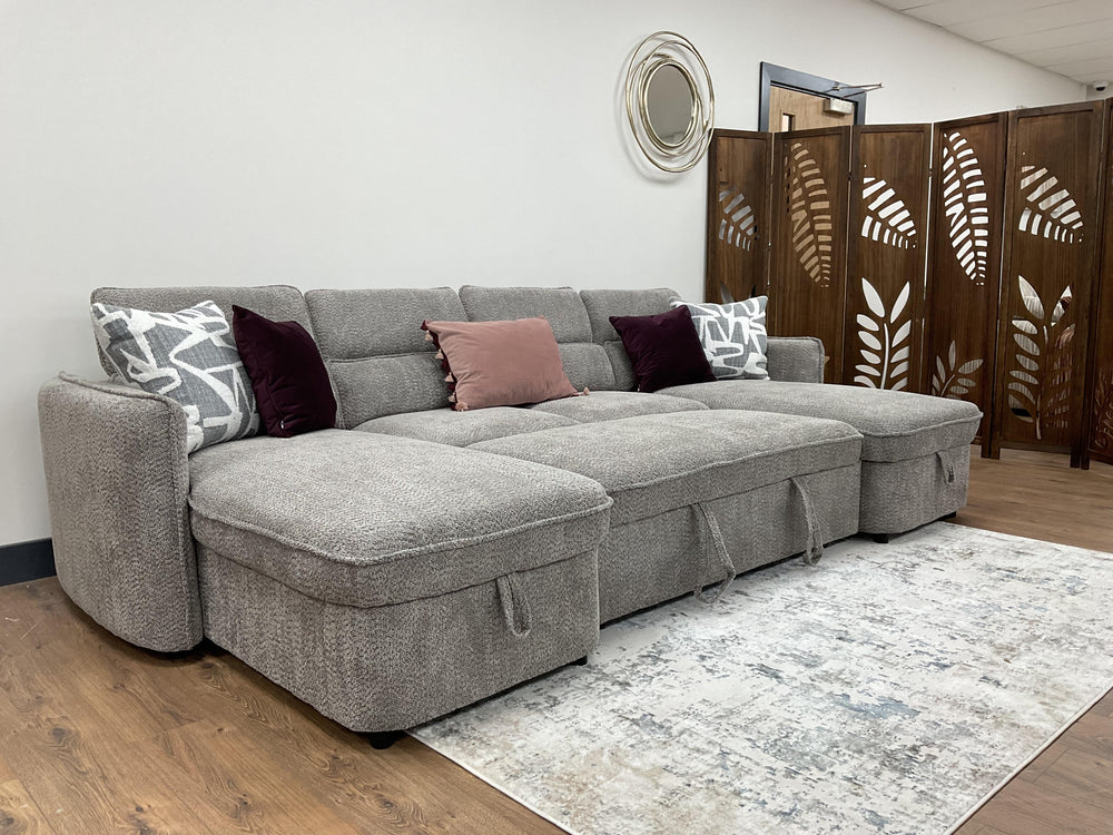 Capri U-shaped sofa bed with raised back cushions and gray woven upholstery