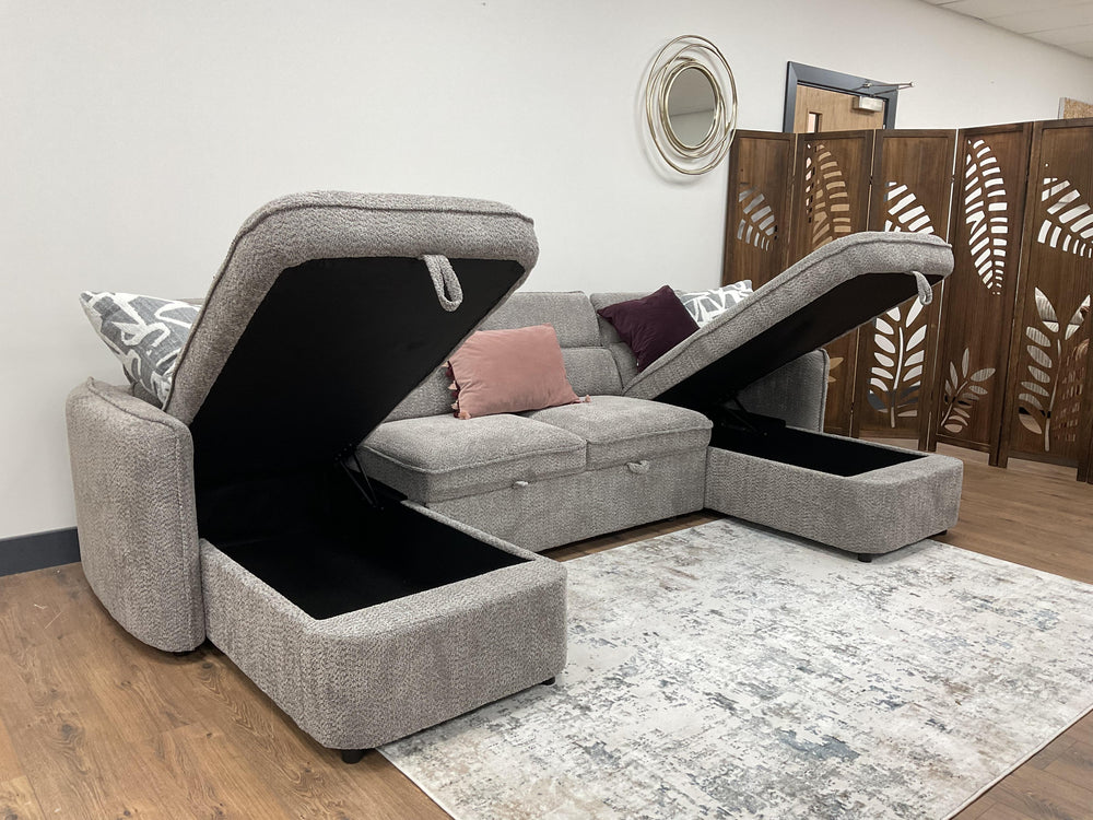 Gray U-shaped sofa bed with raised storage compartments and a pull-out chaise section.