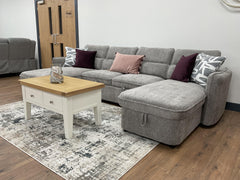 Gray U-shaped sofa bed with a chaise, tufted back cushions, and matching upholstered arms.