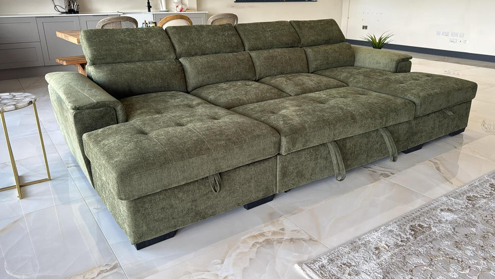 Green sofa bed opened into a wide, flat sleeping surface