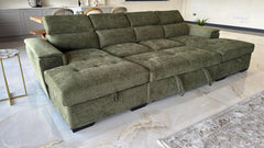 Green sofa bed opened into a wide, flat sleeping surface