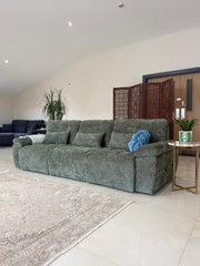 Gray-green 3-seater sofa bed with loose cushions and broad padded arms.