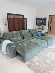 Gray-green 3-seater sofa bed shown with its seat extended into a chaise-like lounge.