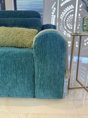 Teal fabric sofa bed armrest with rounded profile and textured upholstery