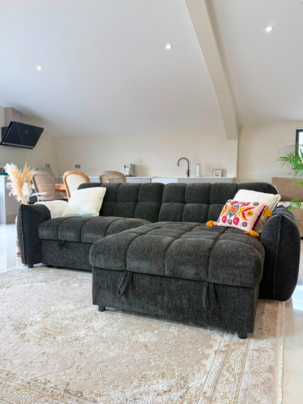 Charcoal sectional sofa bed with a wide chaise and tufted seats