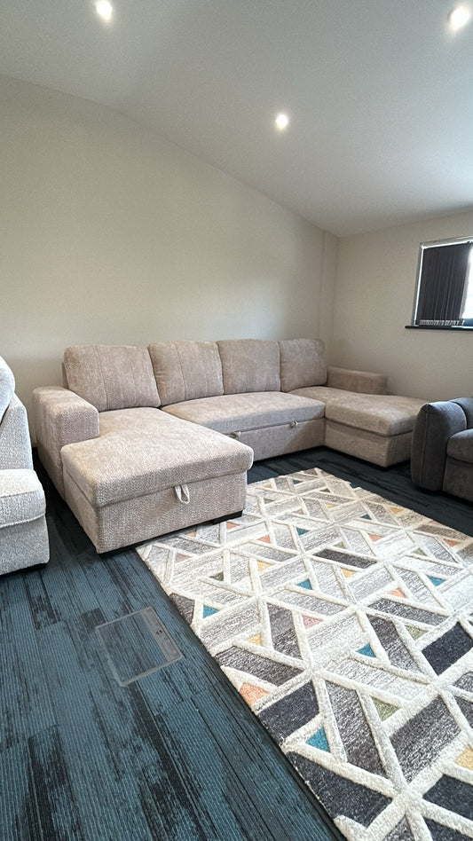 Beige U-shaped sofa bed with one seat section extended