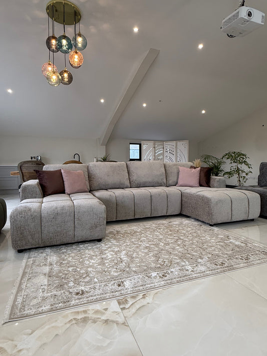 Wide view of the U-shaped sofa bed arranged with its chaise ends