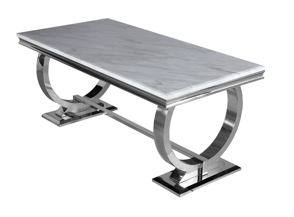 Arriana dining table with light gray veined top and sculptural polished metal base