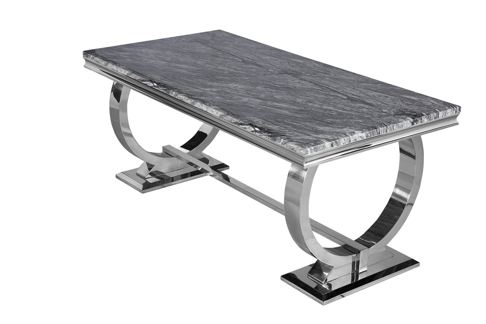 Arriana dining table with dark gray veined stone top and polished metal base