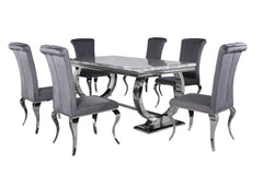 Arriana dining table with gray top, shown with upholstered dining chairs