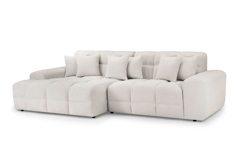 Large light beige corner sofa with plush seats and loose back cushions