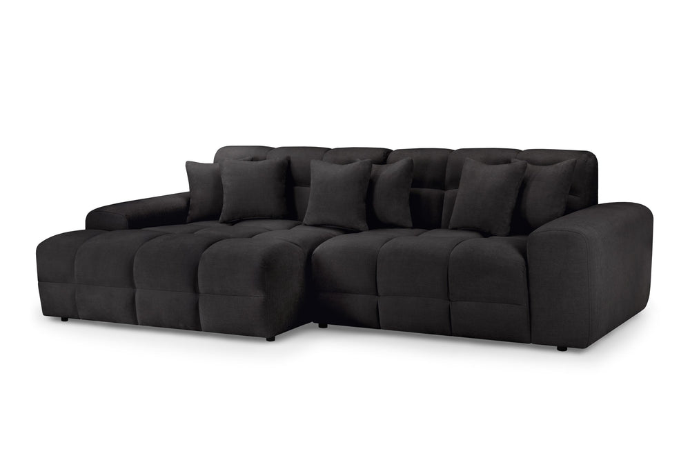 Large dark gray corner sofa with cushioned seats, broad arms, and loose back pillows