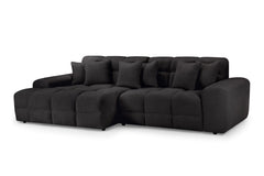 Large dark gray corner sofa with cushioned seats, broad arms, and loose back pillows
