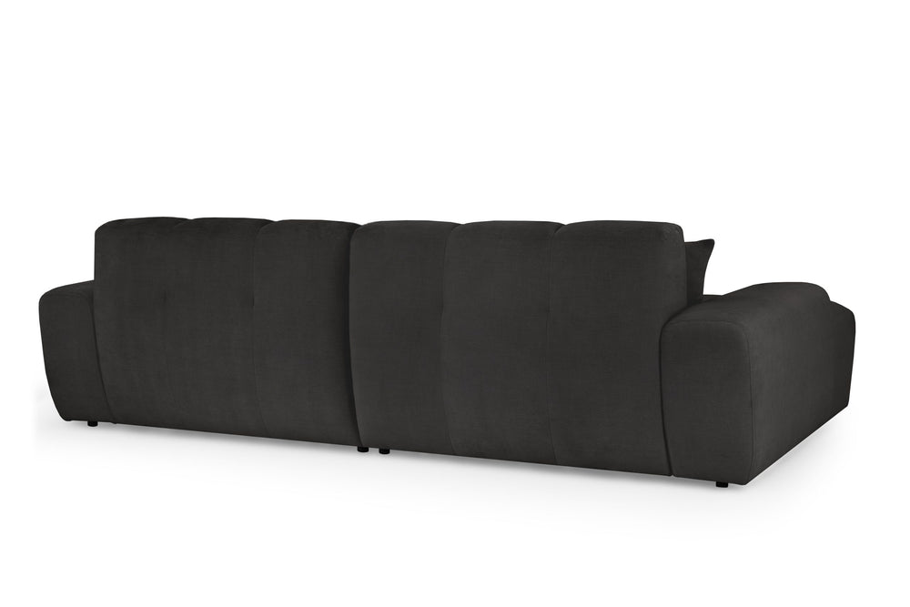 Rear view of the large corner sofa with upholstered back panels and broad arms